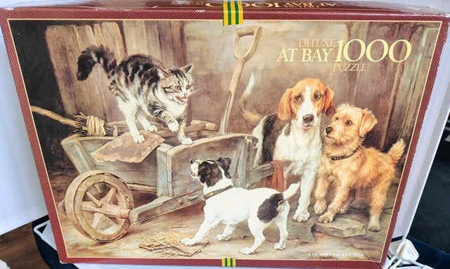 Jigsaw puzzle box featuring cats and dogs around a wheelbarrow