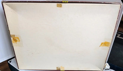 Close-up of a wooden box with gold accents on a white background