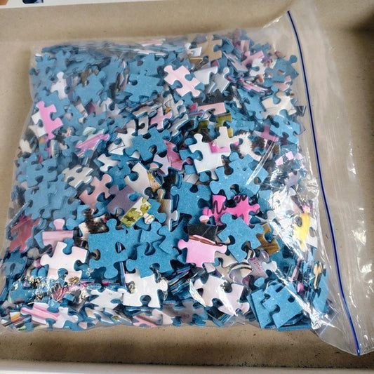 Bag of assorted puzzle pieces on a cardboard surface