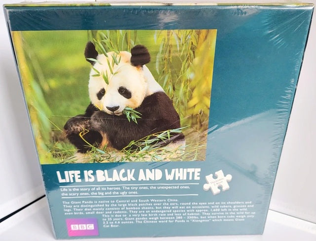 Panda-themed puzzle box with a panda eating bamboo and 'Life is Black and White' text on a white background.