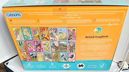 Gibsons British Songbirds puzzle box with colorful bird illustrations on an orange background