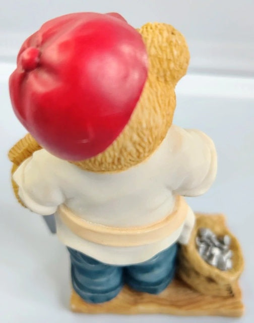 Figurine of a person holding a saw on a white background