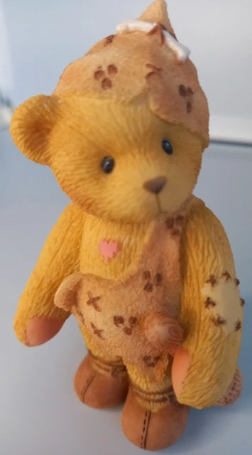 Stuffed teddy bear with a heart on a white background