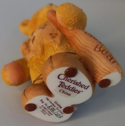 Small bear figurine with 'Cherished Teddies' label on a light background