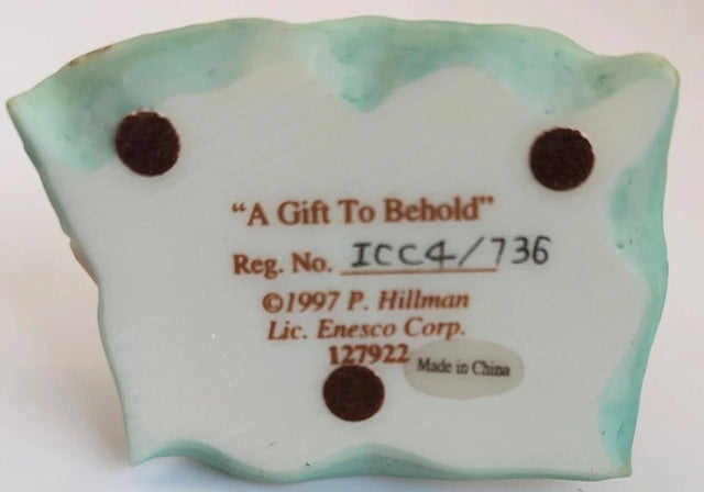 Decorative item with 'A Gift To Behold' text and Enesco Corp. branding on a white background