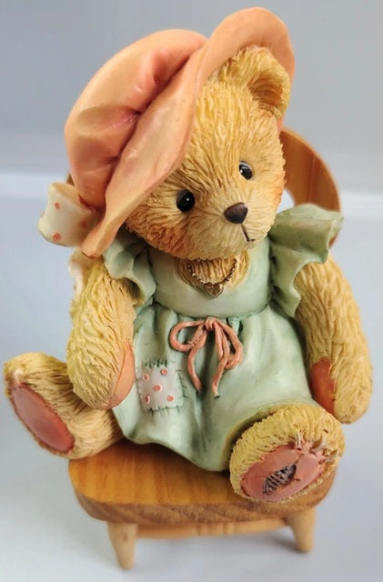 Cherished Teddies A Mothers Love Bears All Things figurine. A bear figurine wearing a dress and hat, sitting on a chair against a light background. 624861.