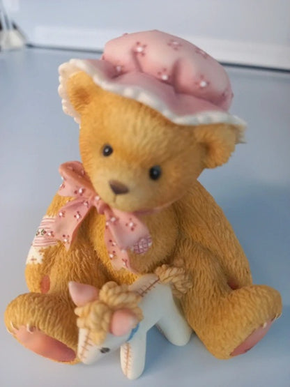 Teddy bear with pink hat and scarf on a white background