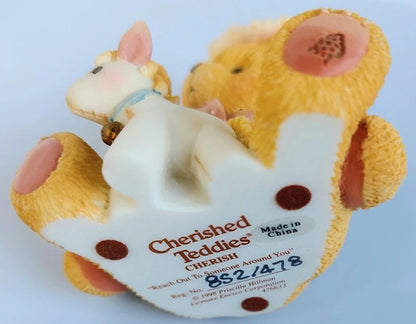 Cherished Teddies Cherish figure of a bear with a smaller bear on its back, branded 'Cherished Teddies', on a white background.