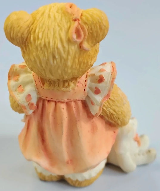 Cherished Teddy bear in an orange dress with a white background