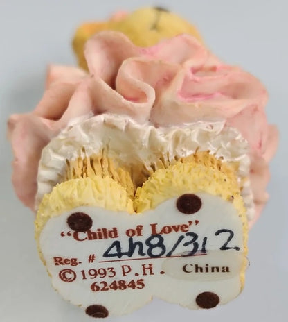 Decorative item with 'Child of Love' label and floral design on a gray background