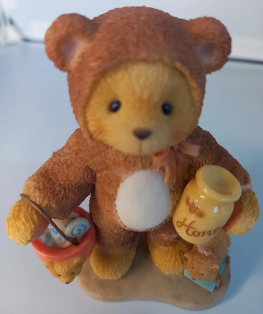 Teddy bear holding a bucket and a jar with 'Honey' on a white background