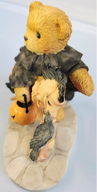 Decorative bear figurine with pumpkins and a bird on a white background