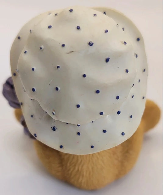 White polka dot hat with purple dots on a white background