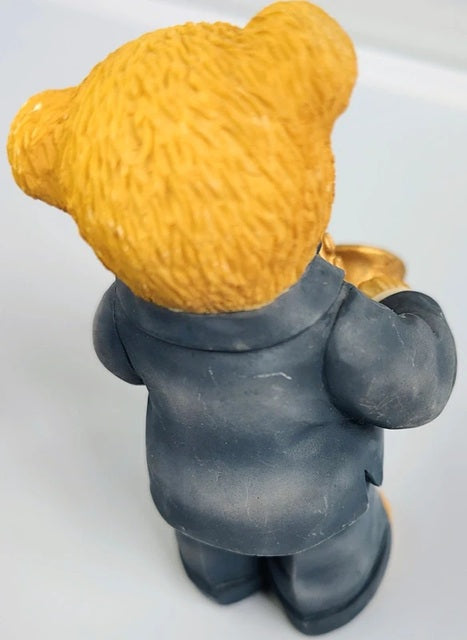 Figurine of a character with a yellow hat and gray coat on a white background