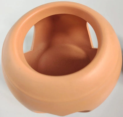Terracotta-colored pot on a light gray background