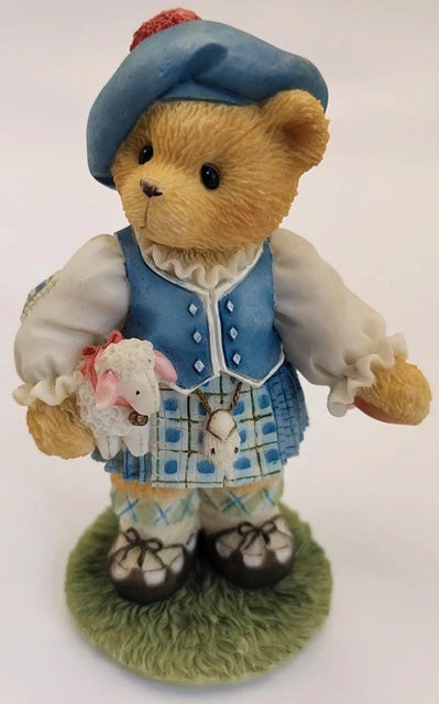 Cherished Teddies Lorna figurine. Scotland bear in a blue outfit with a lamb figurine on a white background