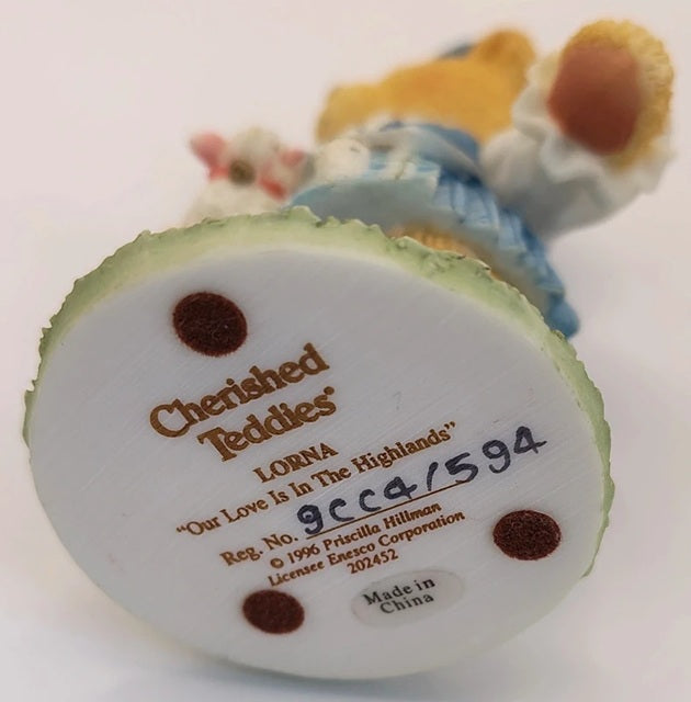 Back view of a 'Cherished Teddies' toy with branding and product details.