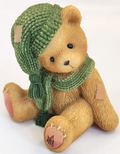 Cherished Teddies Meredith teddy bear wearing a green knitted hat and scarf on a white background. 534226.