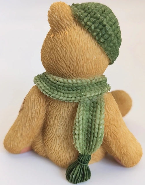 Cherished Teddy bear with a green hat and scarf on a white background