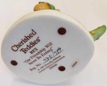 Back view of a 'Cherished Teddies' bear with branding and product details.