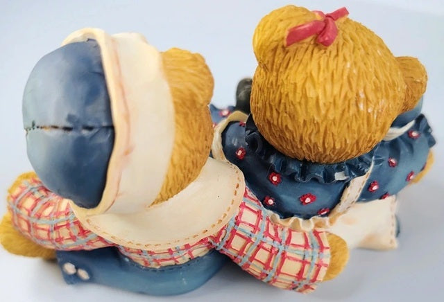 Cherished Teddies Rosemarie and Ronald resin figurines of a couple in traditional attire on a white background
