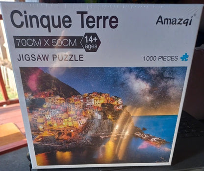 Cinque Terre jigsaw puzzle packaging with mountain village and starry sky design.