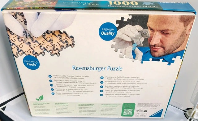 Ravensburger puzzle box with a man and puzzle pieces on the packaging