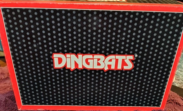 Box with 'Dingbats' logo on a textured surface