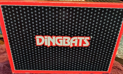 Box with 'Dingbats' logo on a textured surface