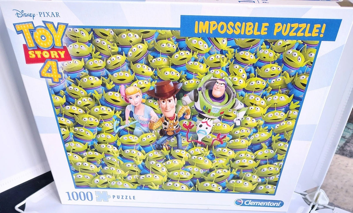 A boxed 1000-piece jigsaw puzzle from Disney Pixar Toy Story 4, featuring a dense collage of green Alien characters with Woody, Buzz Lightyear, and Jessie on the front. The Clementoni brand logo is visible in the bottom right corner.