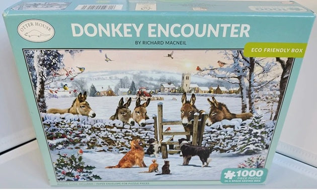 Jigsaw puzzle box titled 'Donkey Encounter' by Richard Macneil with a snowy scene on the cover.