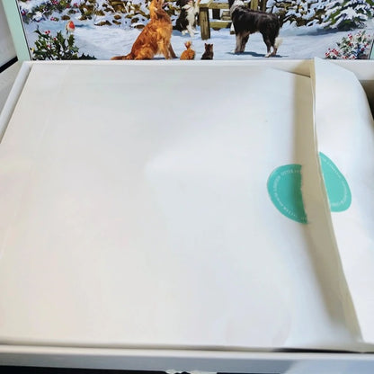 White product with green label on a snowy scene with dogs in the background