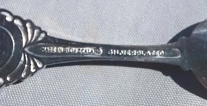 Silver spoon with 'Made in New Zealand' and 'Silverplate' text on a gray background