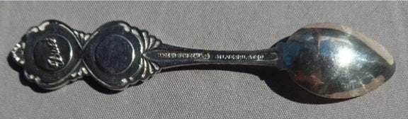 Silver spoon on a gray background