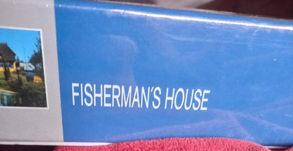 Product packaging with 'Fisherman's House' text on a blue background