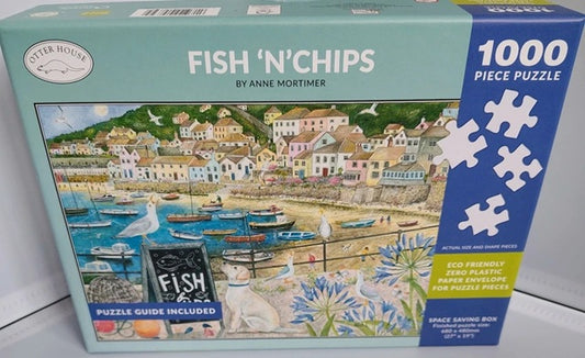 Jigsaw puzzle box titled 'Fish 'n' Chips' by Anne Mortimer with a coastal scene design.