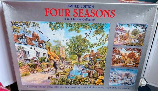 Four seasonal village scenes from a 4 in 1 jigsaw puzzle collection showing spring, summer, autumn and winter artwork.