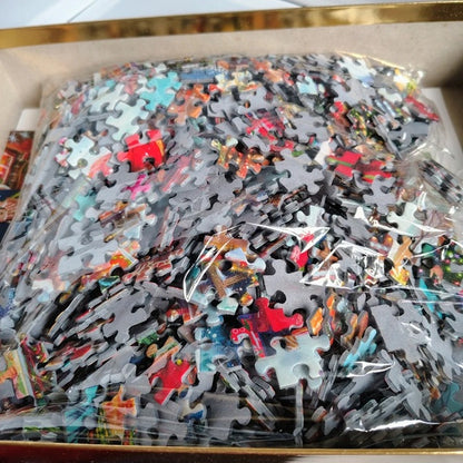 Pile of colorful puzzle pieces in a box
