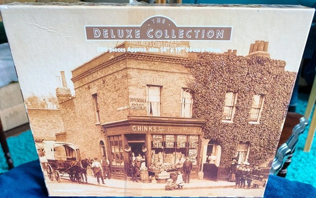 Box labeled 'The Deluxe Collection' with an image of a historical building and people.