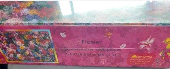 Jigsaw puzzle box with floral design and 'Flower' text on a pink background