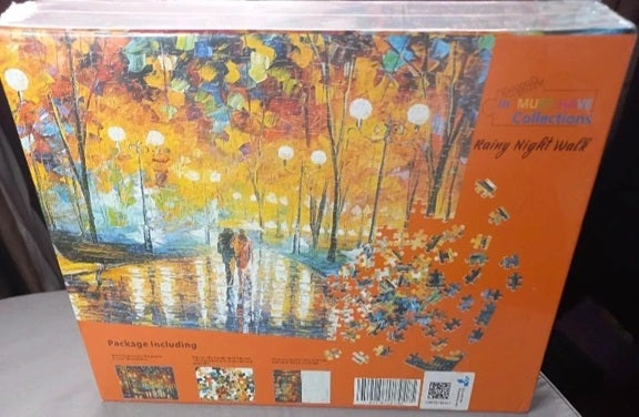 Jigsaw puzzle box with a colorful autumn scene design on an orange background