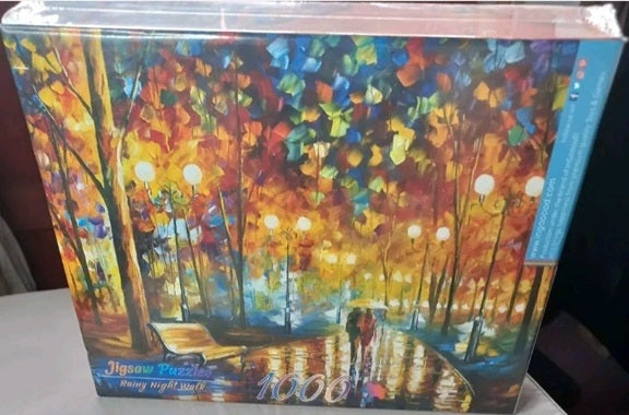 Jigsaw puzzle box with colorful forest design and '1000' pieces visible