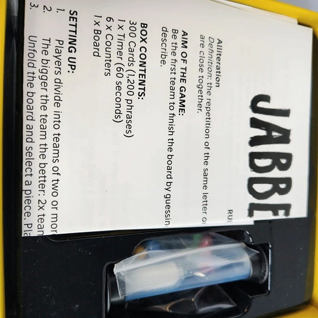 Close-up of a game box with 'JABBER JAW' branding and setup instructions.