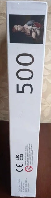 Product packaging with '500' and a brand logo on a wooden surface