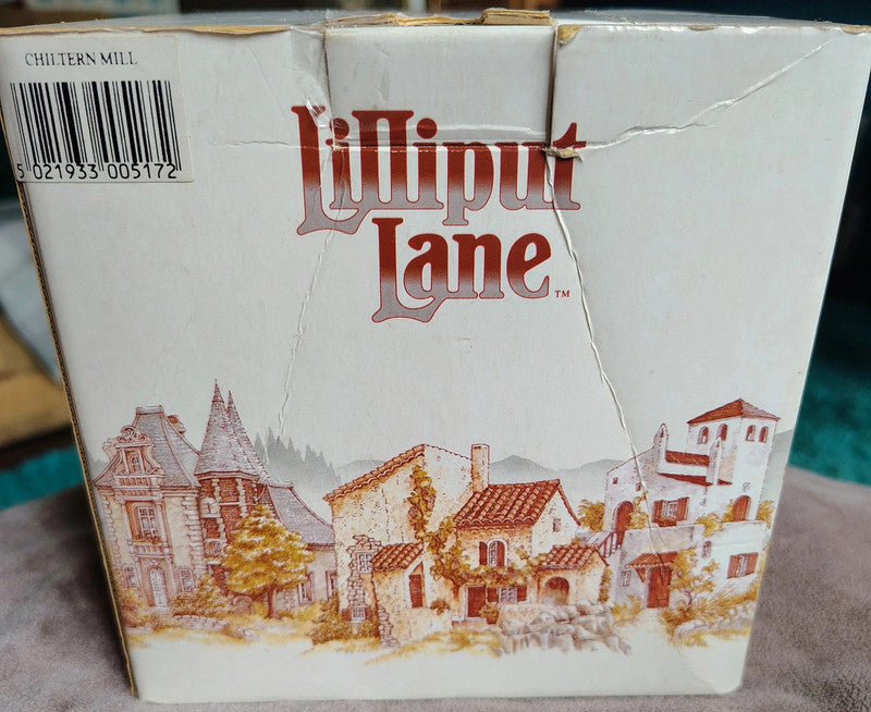 Lilliput Lane packaging with a scenic illustration of houses and mountains.
