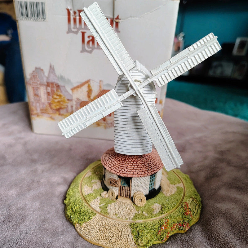 Model of a windmill on a decorative base with a blurred background
