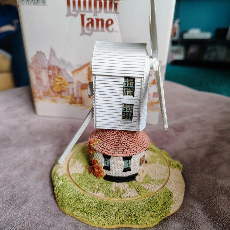 Model of a house on a stand with a blurred background