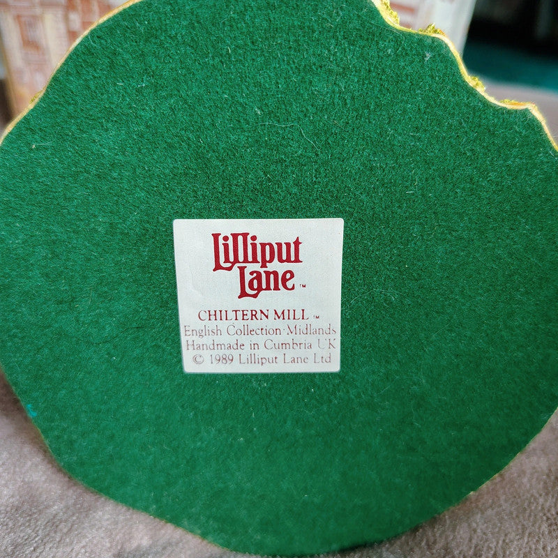 Green felt product with a Lilliput Lane label on a textured surface