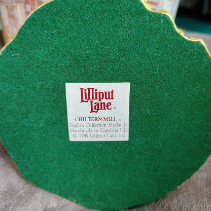 Green felt product with a Lilliput Lane label on a textured surface
