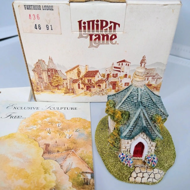 Decorative house sculpture with 'Kipper Lane' packaging on a light blue background